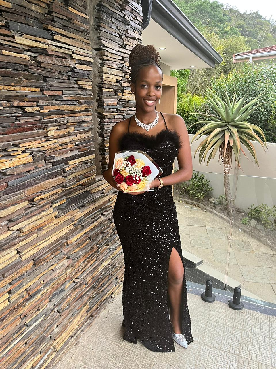 Buyanda dressed for the celebration in a black sequined gown